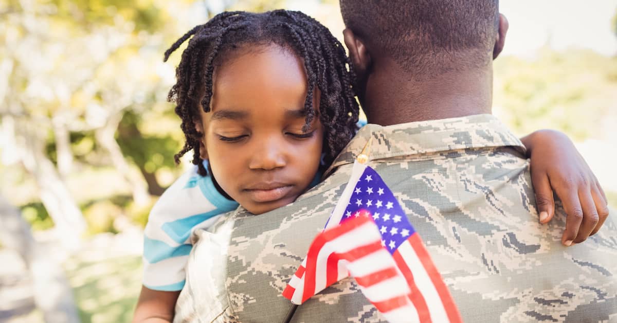 A Small Child Hugs a Veteran | Colling Gilbert Wright and Carter