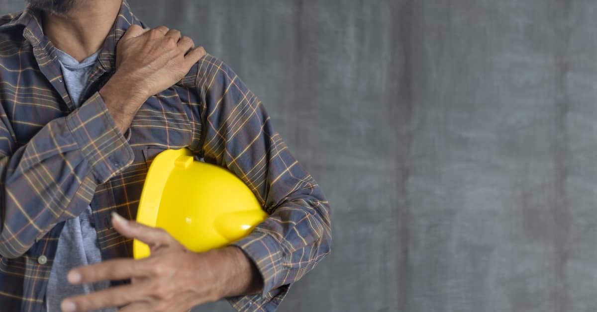 Injured worker holding shoulder. | Colling Gilbert Wright