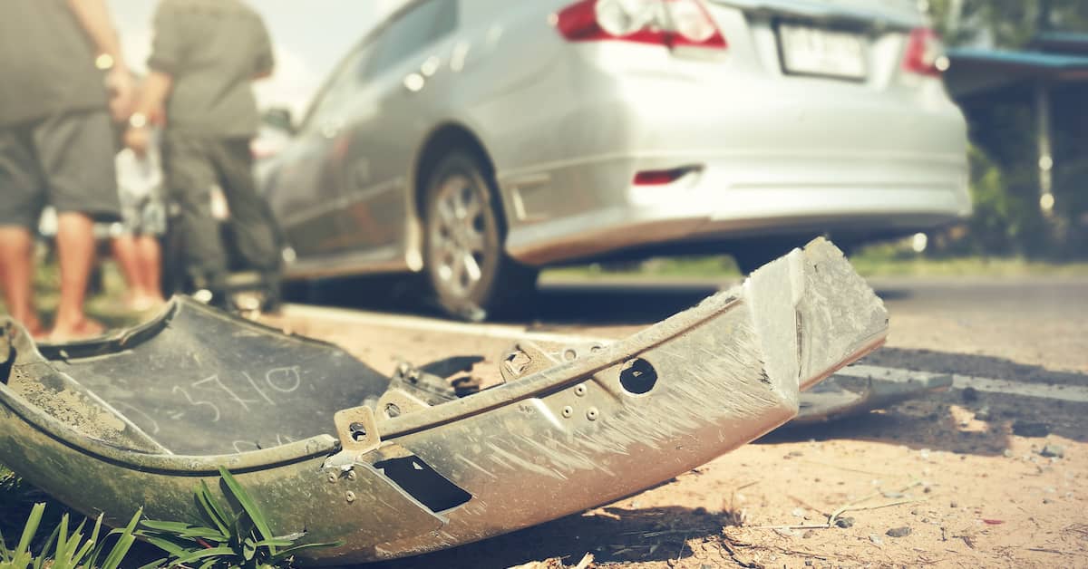a fender lies in the road after a crash | Colling Gilbert Wright