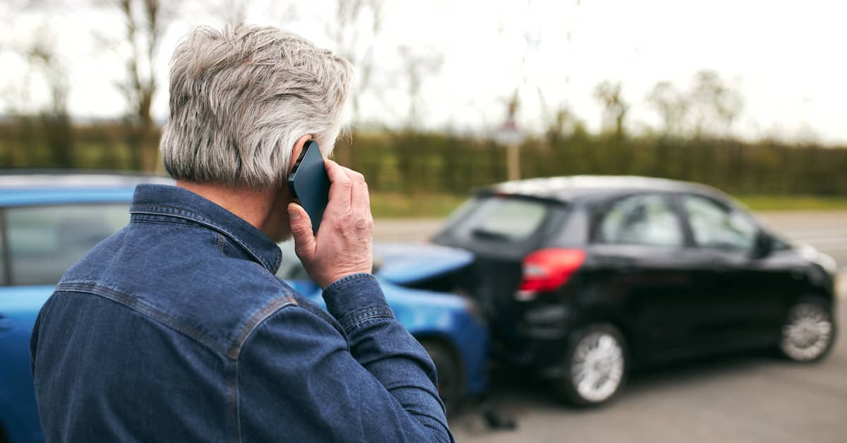 Man on phone after car accident. | Colling Gilbert Wright