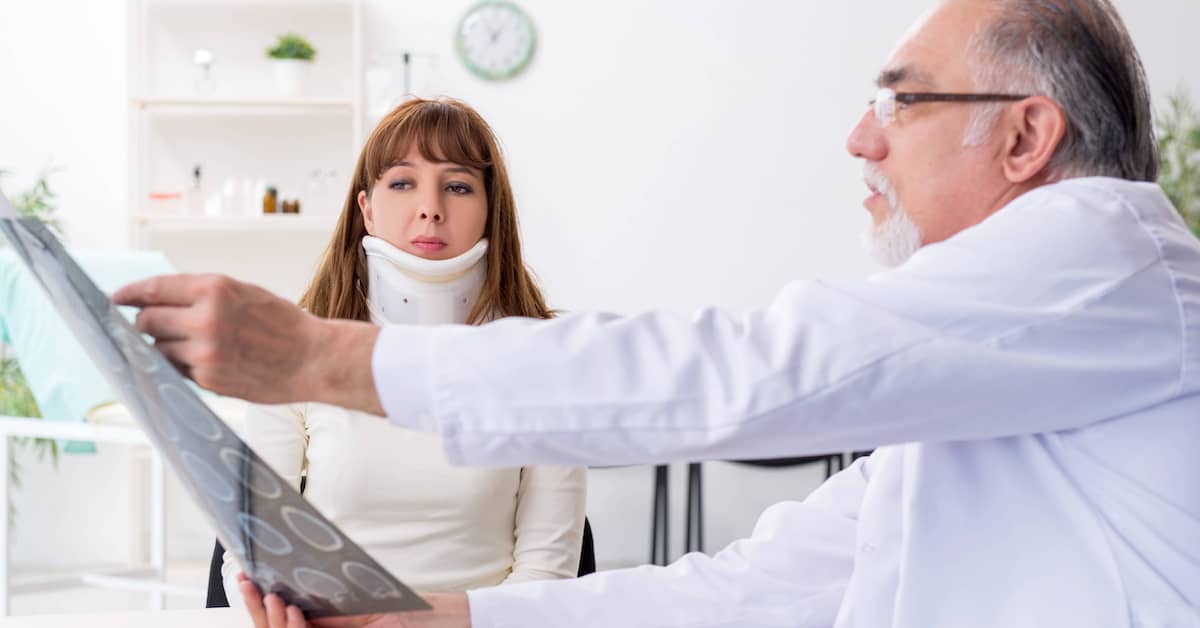 A woman in a neck brace sees a doctor after a car accident. | Colling Gilbert Wright