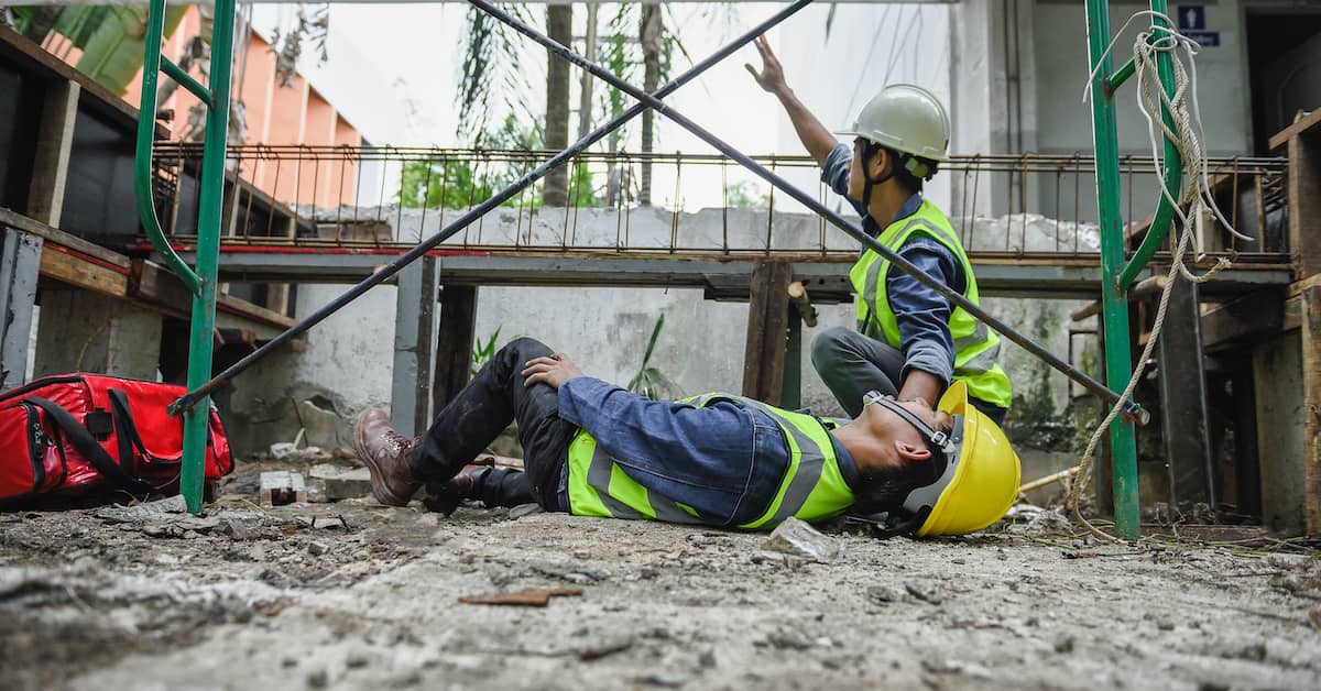 A worker is injured on the ground while another signals for help. | Colling Gilbert Wright