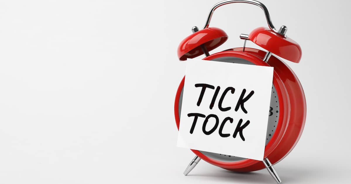 Red alarm clock with "Tick Tock" written on front. | Colling Gilbert Wright