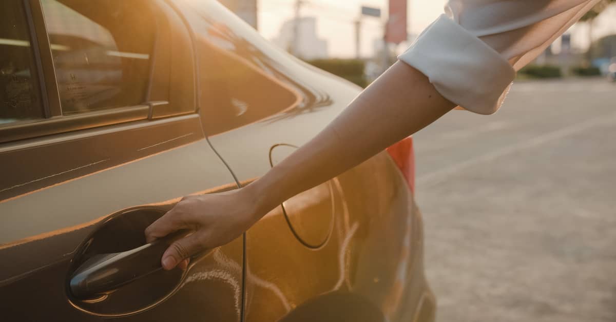 Woman opening door of an Uber. | Colling Gilbert Wright
