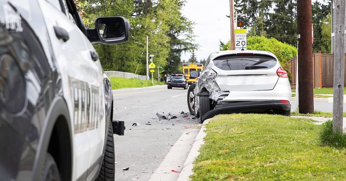 Police cruiser and totaled car on street. | Colling Gilbert Wright